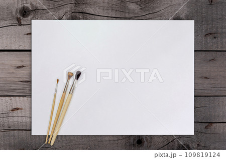 Artist Paint Brush on Blank White Paper. Top View. Drawing Tools in Art Studio. Artist Paint Brush on Blank White Paper. Top View. Drawing Tools in Art Studio. 109819124