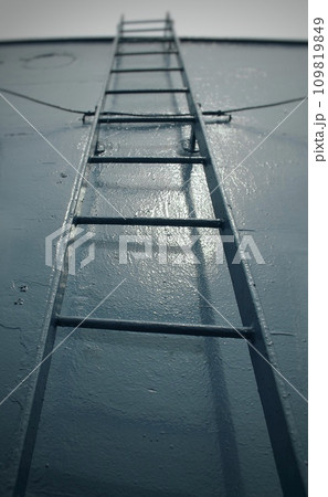 Tall commercial step ladder against the blue wall background at the ocean ship with copyspace. Abstract of business and life concept.  109819849
