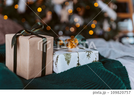 Christmas gift or present box, against magic bokeh background. Beautiful Christmas gift boxes with ribbon. Christmas gift or present box, against magic bokeh background. Beautiful Christmas gift boxes with ribbon. 109820757
