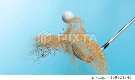 Golf ball tee explode from sand bunker. Golfer hit ball with club to sand explosion to summer sky. Golf club hit ball tee in sand wedge bunker explosion. Blue sky background isolated freeze motion 109821249