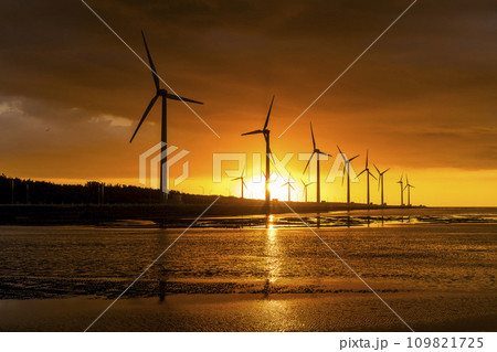 Sunset view of the Gaomei wetlands landscape and the wind power systems in Taichung, Taiwan. energy systems and renewable energy. Sunset view of the Gaomei wetlands landscape and the wind power systems in Taichung, Taiwan. energy systems and renewable energy. 109821725