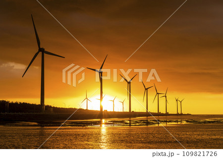 Sunset view of the Gaomei wetlands landscape and the wind power systems in Taichung, Taiwan. energy systems and renewable energy. Sunset view of the Gaomei wetlands landscape and the wind power systems in Taichung, Taiwan. energy systems and renewable energy. 109821726