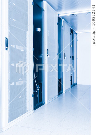 A row of racks with data storage hardware inside server room 109822341