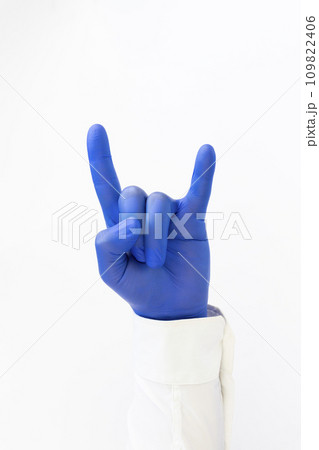 Hand in blue latex Glove giving Devil sign. Heavy metal Hand in blue latex Glove giving Devil sign. Heavy metal 109822406