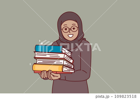 Arab little girl in hijab holds religious books with prayers in hands and looks at screen with smile 109823518