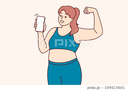 Plump woman in fitness clothes demonstrates biceps and encourages use mobile phone with sports apps Plump woman in fitness clothes demonstrates biceps and encourages use mobile phone with sports apps 109823601