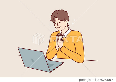 Man prays sitting in front laptop and watching broadcast religious event from catholic church Man prays sitting in front laptop and watching broadcast religious event from catholic church 109823607