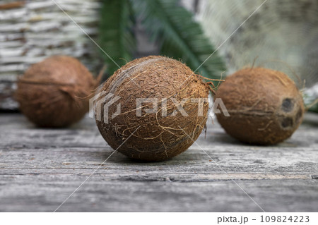 Coconuts on a old rustic wooden surface Coconuts on a old rustic wooden surface 109824223
