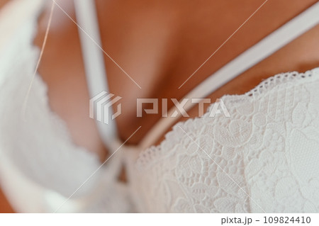 A mid-30s happy woman with long hair natural color poses in her underwear, smiling in front of a brick wall on a construction site for model tests A mid-30s happy woman with long hair natural color poses in her underwear, smiling in front of a brick wall on a construction site for model tests 109824410
