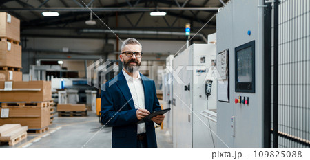 Banner of male project manager standing in modern industrial factory. Manufacturing facility with robotics and automation. Storing products and materials in warehouse. Banner with copy space. Banner of male project manager standing in modern industrial factory. Manufacturing facility with robotics and automation. Storing products and materials in warehouse. Banner with copy space. 109825088