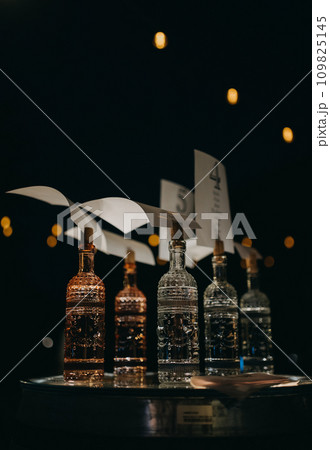 Decorative alcohol, liquor decanter displayed on table. Luxury bottles as holder. Decorative alcohol, liquor decanter displayed on table. Luxury bottles as holder. 109825145