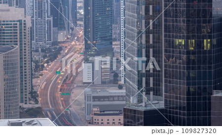 Aerial view from above to a busy road intersection in Dubai night to day timelapse. Aerial view from above to a busy road intersection in Dubai night to day timelapse. 109827320