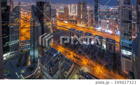 High-rise buildings on Sheikh Zayed Road in Dubai aerial night to day timelapse, UAE. High-rise buildings on Sheikh Zayed Road in Dubai aerial night to day timelapse, UAE. 109827321