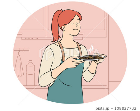 Happy woman smell food in kitchen Happy woman smell food in kitchen 109827732