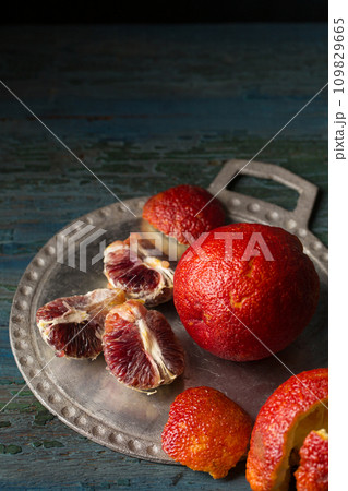 burgundy orange on a plate, still life burgundy orange on a plate, still life 109829665