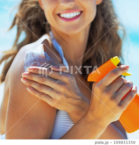 Closeup on smiling young woman with sun screen creme Closeup on smiling young woman with sun screen creme 109831350