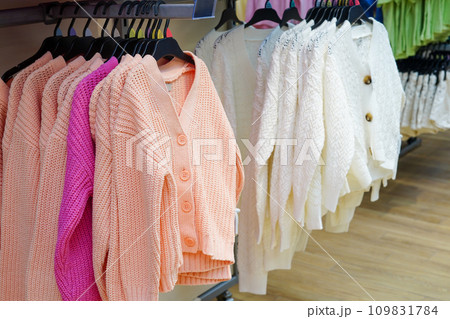 Children clothes hanging on hangers in the shop 109831784