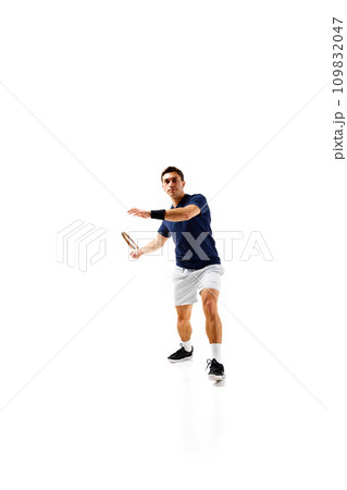 Full-length image of young man, tennis athlete in motion, playing, practicing isolated over white background 109832047