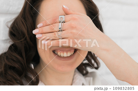 Women Jewelry concept. Woman's hands close up wearing rings and necklace modern accessories elegant lifestyle. Funny girl 109832805