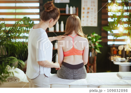 therapist woman checking back condition during examination therapist woman checking back condition during examination 109832898