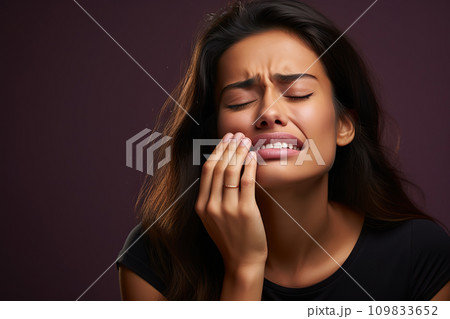 Dental Discomfort Woman Expressing Toothache, Clutching Cheek on a Radiant Purple Background. created with Generative AI 109833652