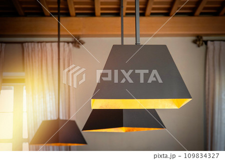 Modern hanging lamps in a classic cozy interior Modern hanging lamps in a classic cozy interior 109834327