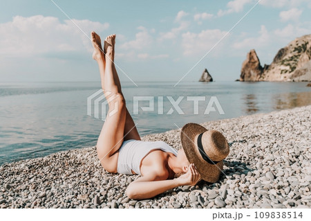 Woman white bikini beach tan. Happy woman in swimwear and hat on vacation. Summer travel holidays vacation on the sea 109838514