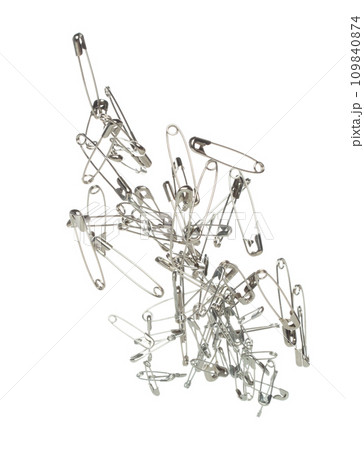 Safety Pin brooch pour fall down, explosion in air. Many safety pin small size splash fly in group floating. White background isolated high speed shutter freeze motion 109840874