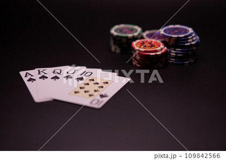 Poker Hands - Royal Flush. Five playing cards - the poker royal flush hand. Royal Flash, card deck, poker royal flash on cards and poker chips on green casino table. success in gambling. soft focus 109842566