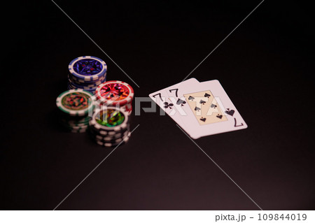 The interior of the casino. Playing cards close-up at the poker table combination of cards a pair of sevens. 109844019