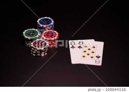 The interior of the casino. Playing cards close-up at the poker table combination of cards a pair of eights. 109844116