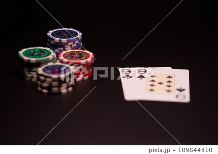 The interior of the casino. Playing cards close-up at the poker table combination of cards a pair of nines. 109844310