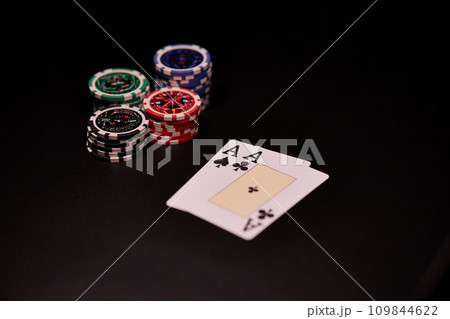 The interior of the casino. Playing cards close-up at the poker table combination of cards a pair of aces. The interior of the casino. Playing cards close-up at the poker table combination of cards a pair of aces. 109844622