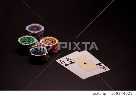 The interior of the casino. Playing cards close-up at the poker table combination of cards a pair of aces. The interior of the casino. Playing cards close-up at the poker table combination of cards a pair of aces. 109844625