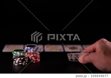 Dealer or croupier shuffles poker cards in a casino on the background of a table, chips. Concept of poker game, game business. Playing for money, a big win, a jackpot, gambling, a desire to get rich. Dealer or croupier shuffles poker cards in a casino on the background of a table, chips. Concept of poker game, game business. Playing for money, a big win, a jackpot, gambling, a desire to get rich. 109844677