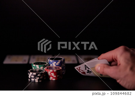 Dealer or croupier shuffles poker cards in a casino on the background of a table, chips. Concept of poker game, game business. Playing for money, a big win, a jackpot, gambling, a desire to get rich. Dealer or croupier shuffles poker cards in a casino on the background of a table, chips. Concept of poker game, game business. Playing for money, a big win, a jackpot, gambling, a desire to get rich. 109844682