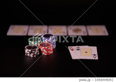 Dealer or croupier shuffles poker cards in a casino on the background of a table, chips. Concept of poker game, game business. Playing for money, a big win, a jackpot, gambling, a desire to get rich.	 109844691