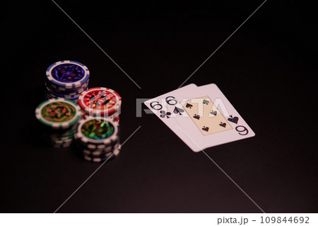 Dealer or croupier shuffles poker cards in a casino on the background of a table, chips. Concept of poker game, game business. Playing for money, a big win, a jackpot, gambling, a desire to get rich.	 109844692