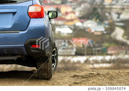 Close up of blue off road car wheel on gravel road. Traveling by auto on a SUV automobile. Offroad 4x4 vehicle detail 109845074