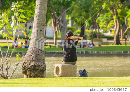 Woman sitting in the park 109845687