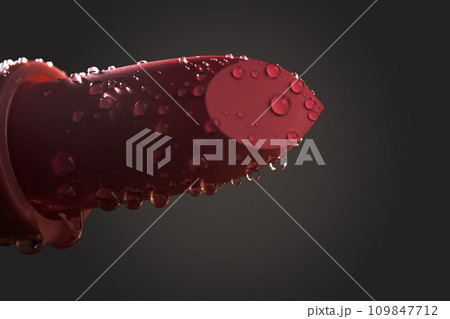 Red lipstick with water drops on a dark background. Red lipstick with water drops on a dark background. 109847712