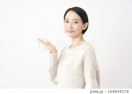 左側を掌で指す中年女性 白背景 左側を掌で指す中年女性 白背景 109848578