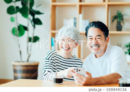 一緒にスマホを見ているシニア夫婦。 109849136