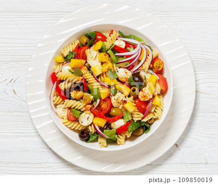 fusilli salad with mozzarella, veggies in a bowl fusilli salad with mozzarella, veggies in a bowl 109850019