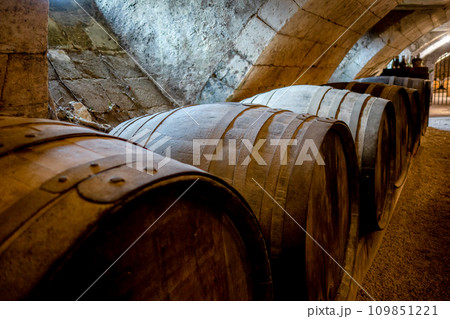Barrels in a rustic wine cellar Barrels in a rustic wine cellar 109851221