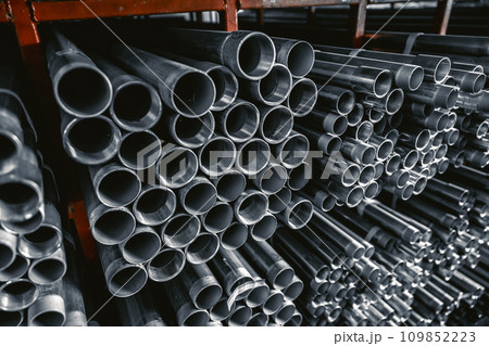 Metal pipes connector tubes. Construction cylindrical steel pipe stacked valious size in construction equipment store shelf. 109852223