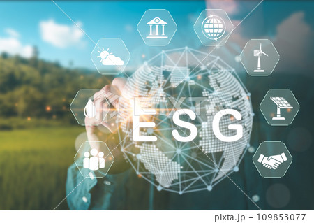 Businessman pointing ESG environment social governance text and environment icons hologram for climate change action, net zero and sustainable living concept. Businessman pointing ESG environment social governance text and environment icons hologram for climate change action, net zero and sustainable living concept. 109853077