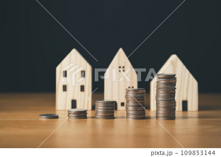 real estate investing and saving money concept.coins stack with house icon and background. 109853144