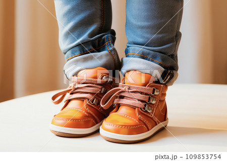 Close-up of children's orange brown leather shoes, dressed for a child 109853754
