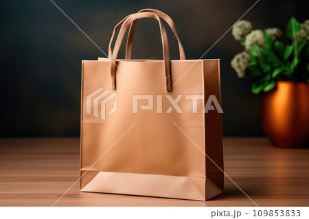 Empty brown paper carrier bag with shopping handles on the table. Mockup for logo application 109853833